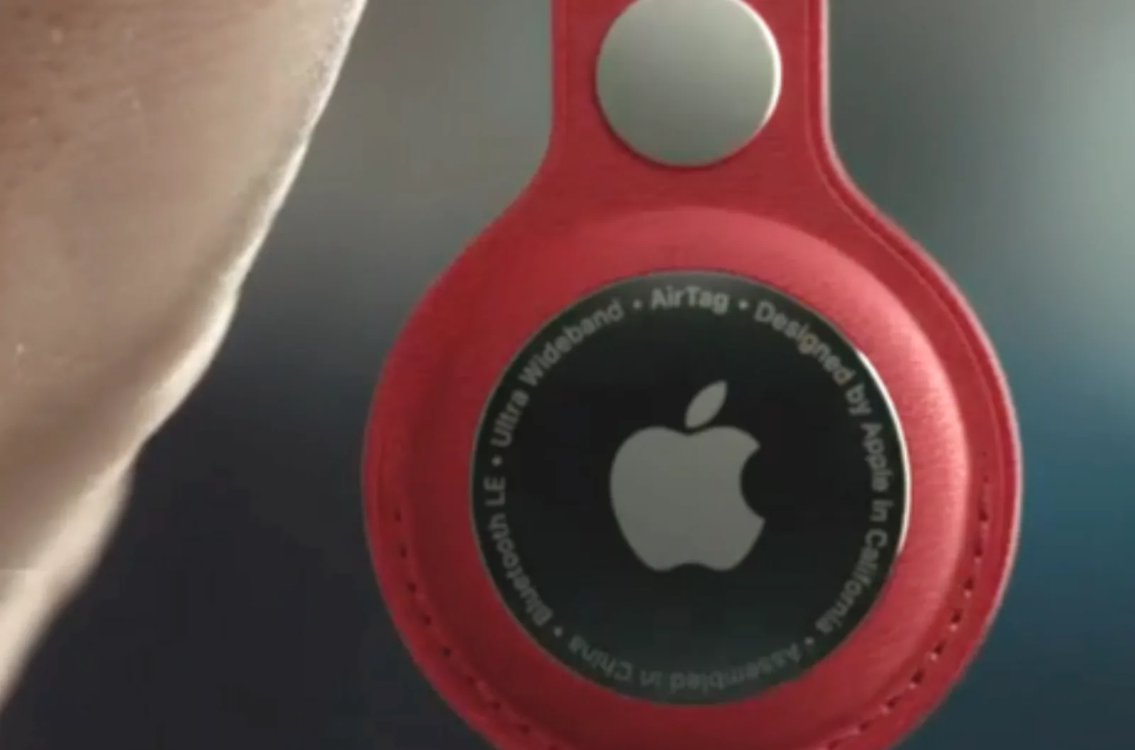 Apple AirTag in a red holder.
